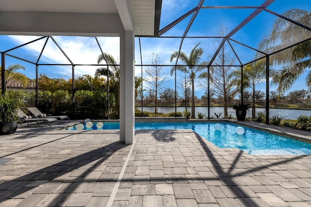 view of pool featuring a water view, a lanai, and a patio area