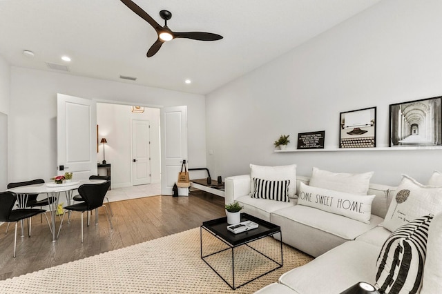 living room with ceiling fan, lofted ceiling, and wood-type flooring