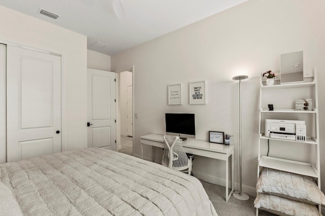 bedroom featuring light carpet and a closet