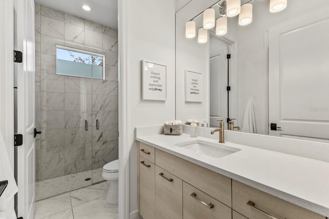 bathroom featuring vanity, toilet, and a shower with shower door