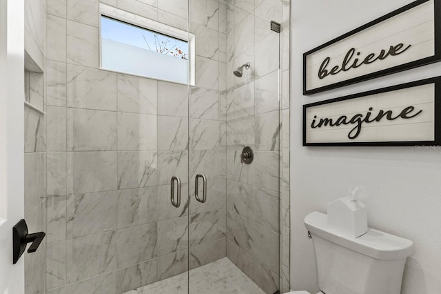 bathroom with an enclosed shower and toilet