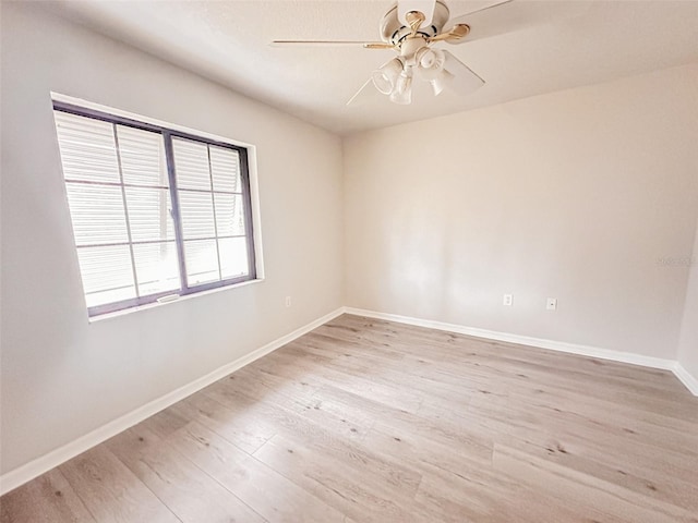 empty room with ceiling fan and light hardwood / wood-style floors