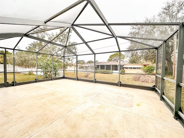 view of patio featuring glass enclosure