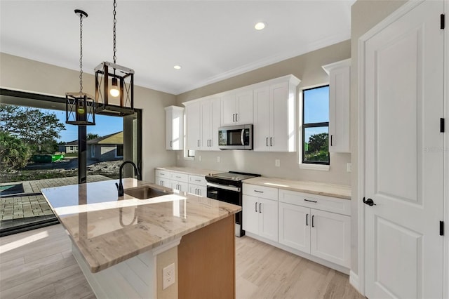 kitchen with sink, pendant lighting, white cabinetry, an island with sink, and electric stove