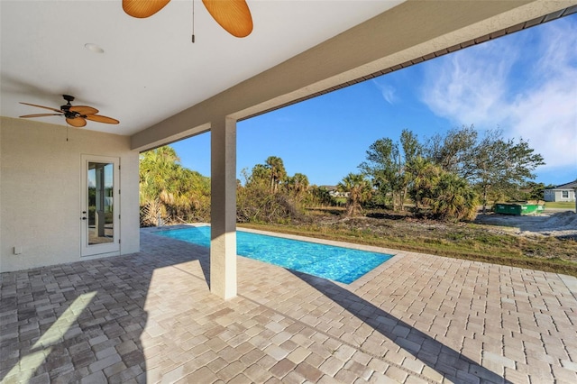 view of swimming pool featuring a patio area and ceiling fan