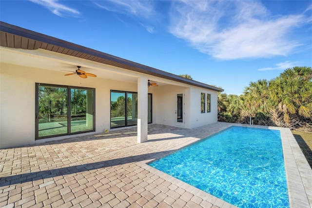 view of swimming pool with a patio and ceiling fan