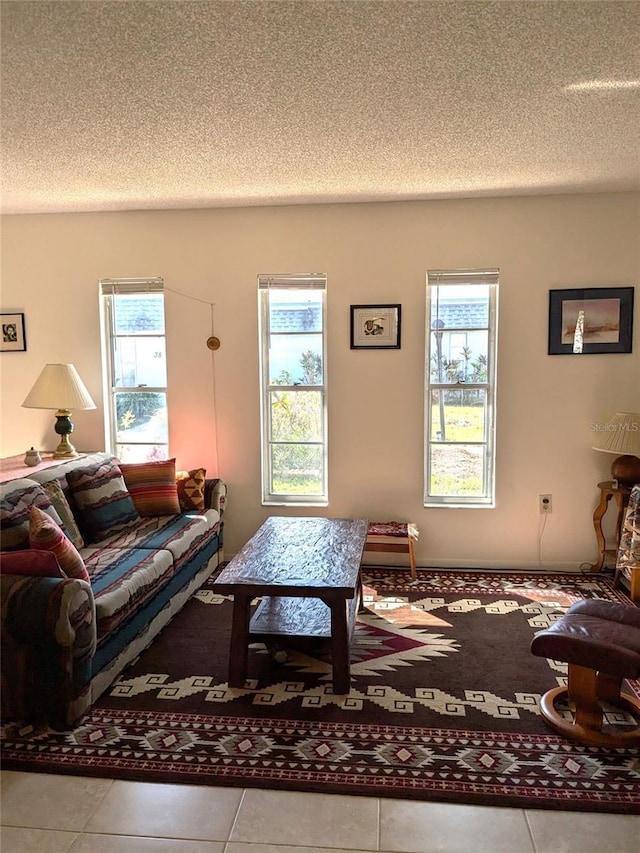 living room with tile patterned floors and a textured ceiling