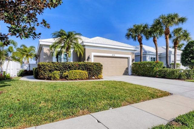 view of front of home featuring a garage and a front yard