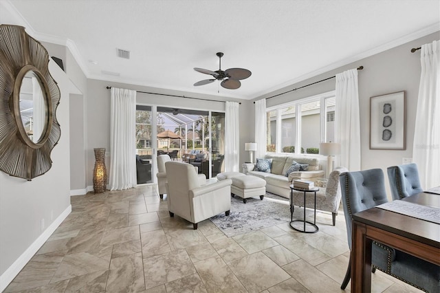 living room featuring crown molding and ceiling fan