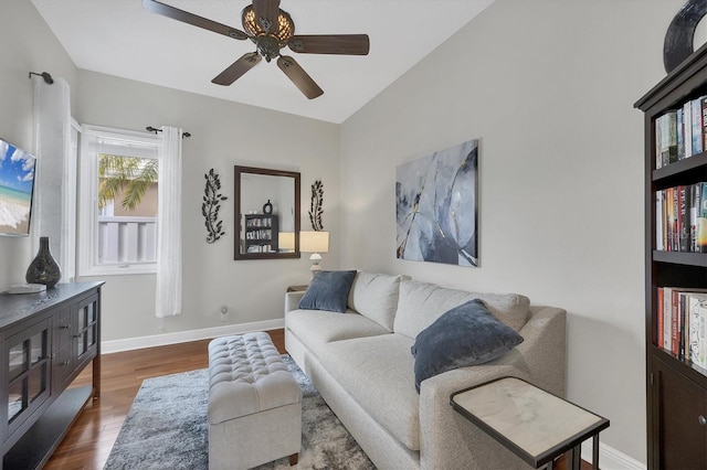 living room with vaulted ceiling, dark hardwood / wood-style floors, and ceiling fan