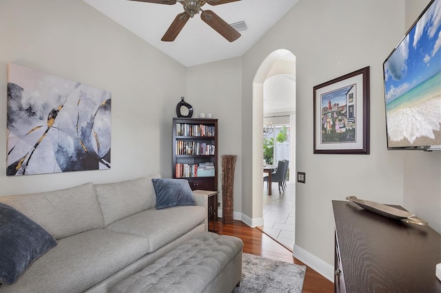 living room featuring dark hardwood / wood-style floors and ceiling fan