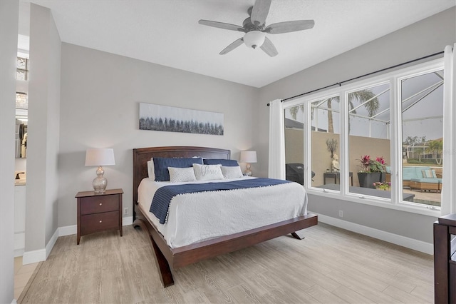 bedroom with ceiling fan and light hardwood / wood-style floors