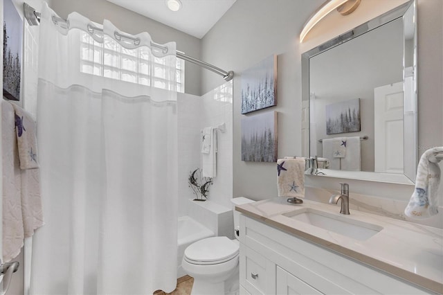 full bathroom featuring vanity, shower / tub combo, and toilet