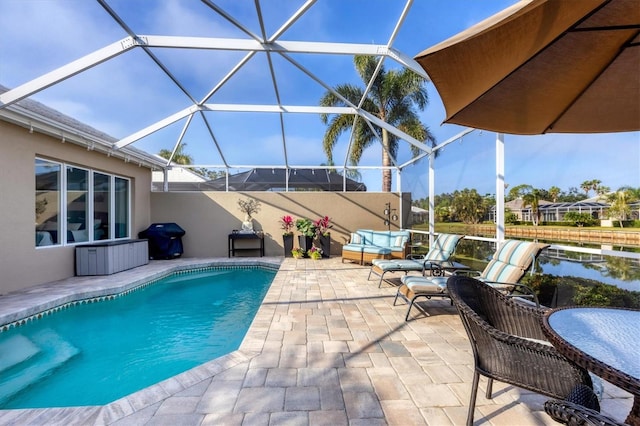 view of swimming pool with a lanai and a patio area