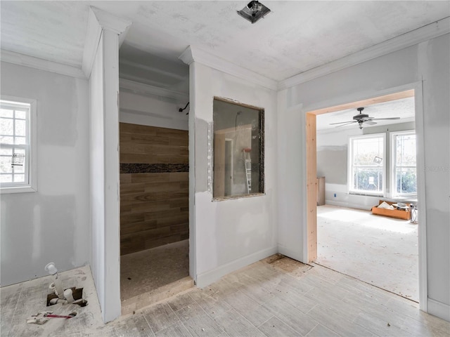 bathroom featuring crown molding and a healthy amount of sunlight