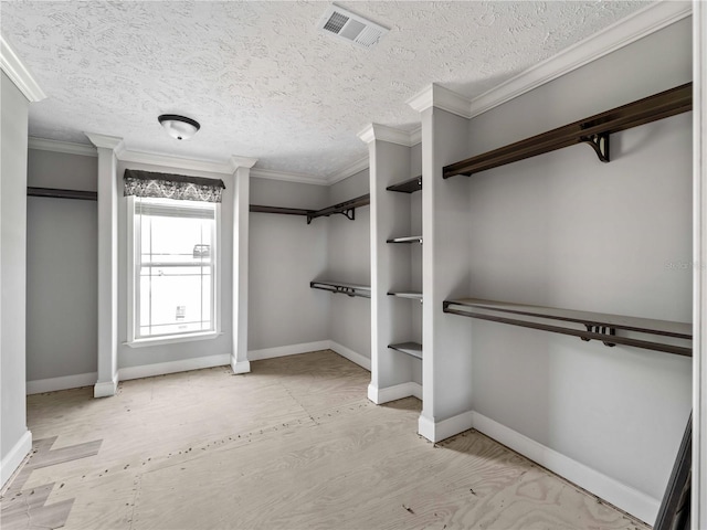 spacious closet featuring light hardwood / wood-style floors