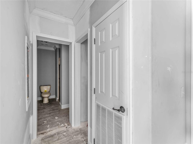 hall featuring crown molding and light hardwood / wood-style floors