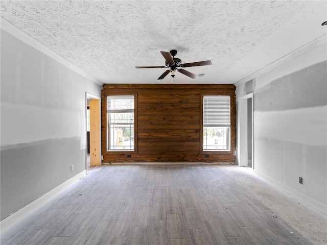 empty room featuring hardwood / wood-style flooring, plenty of natural light, and a textured ceiling