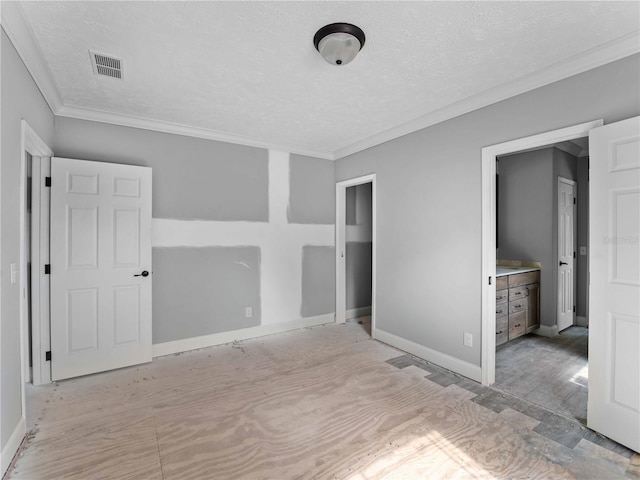 unfurnished bedroom featuring crown molding and a textured ceiling