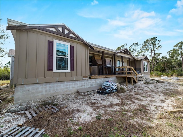 rear view of house with covered porch