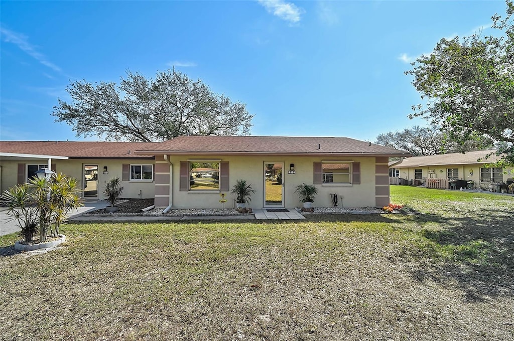 ranch-style home with a front yard