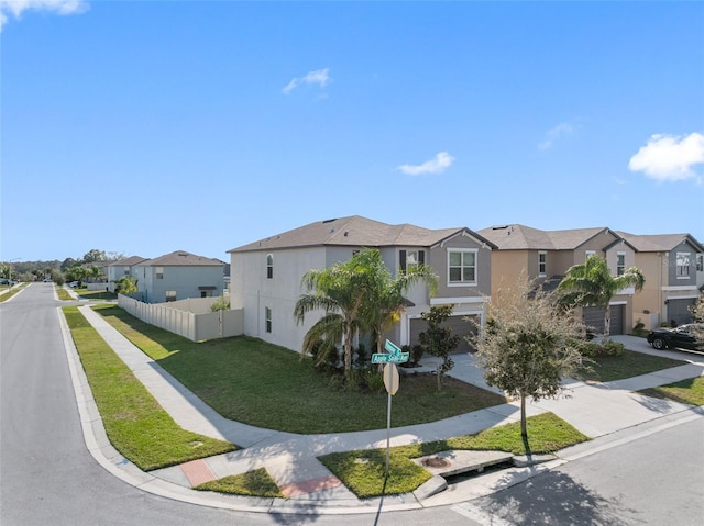 view of front of house featuring a garage and a front lawn