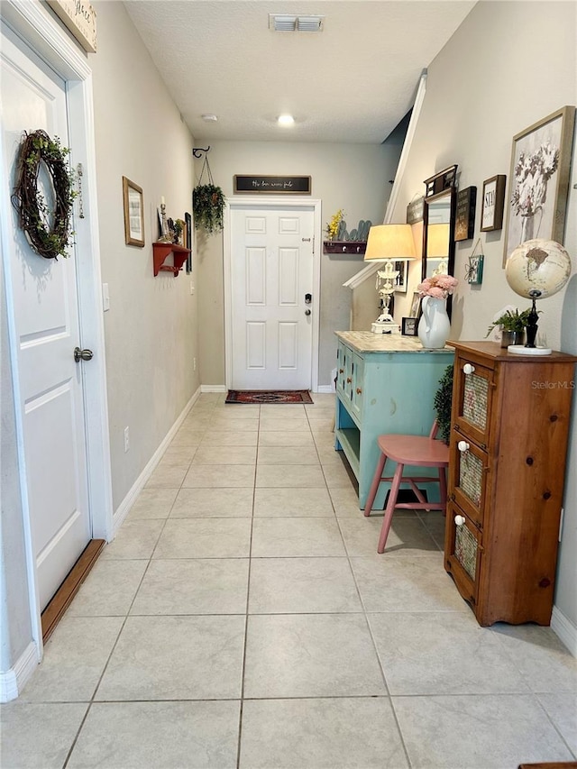 hallway featuring light tile patterned floors