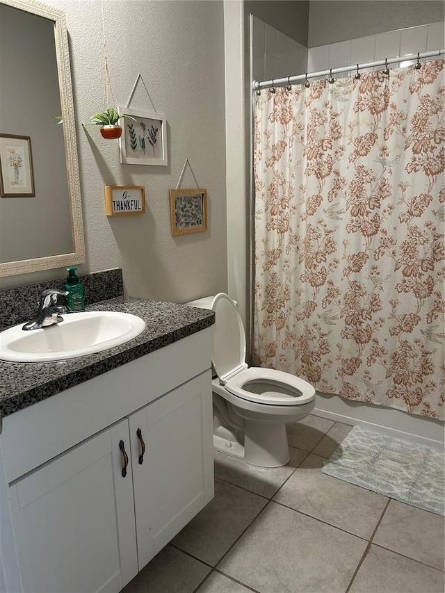 bathroom with vanity, a shower with shower curtain, tile patterned floors, and toilet