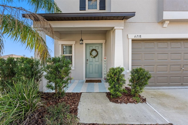 doorway to property with a garage