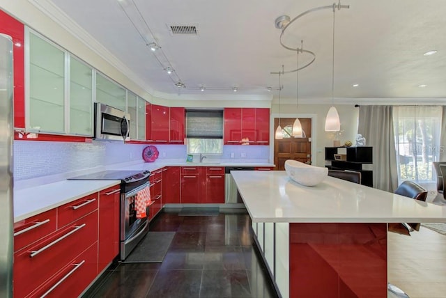 kitchen with red cabinetry, appliances with stainless steel finishes, visible vents, and tasteful backsplash