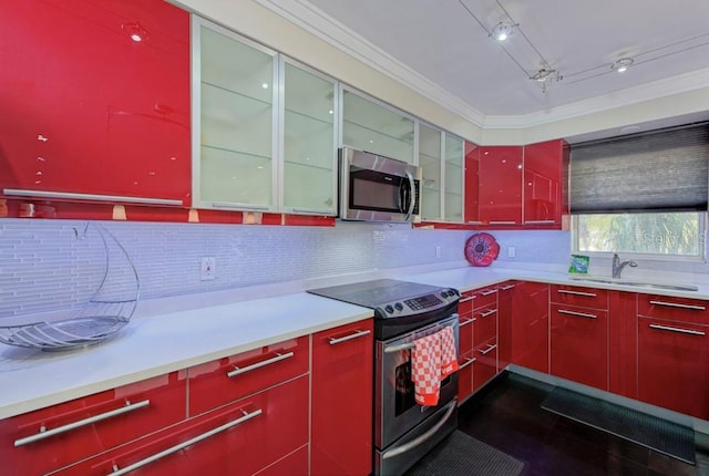 kitchen featuring red cabinetry, stainless steel appliances, backsplash, and ornamental molding