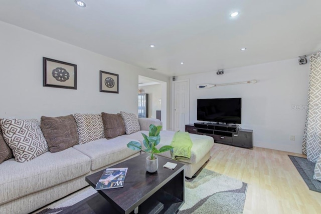 living area with wood finished floors and recessed lighting