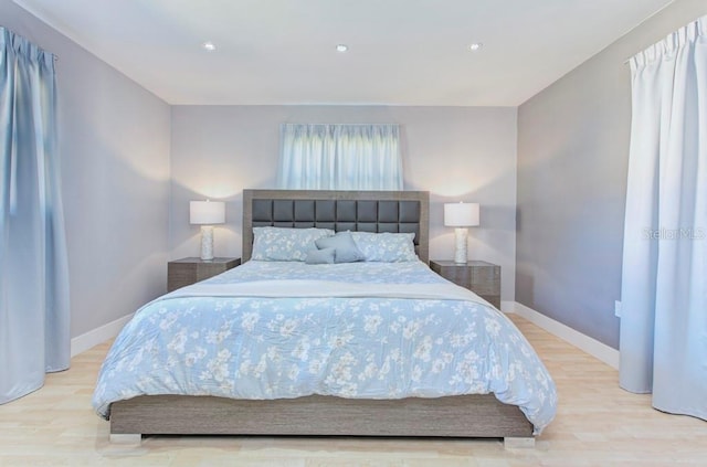 bedroom featuring recessed lighting, wood finished floors, and baseboards