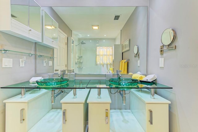 bathroom with a shower and visible vents