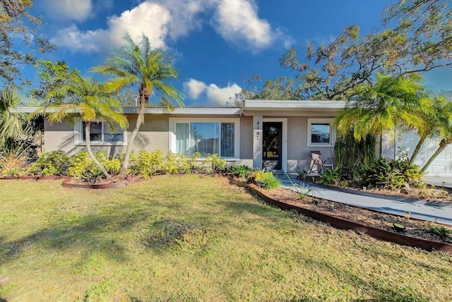 single story home featuring a front yard and stucco siding