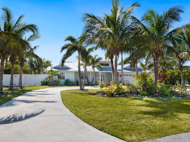 view of front of property featuring a garage and a front yard