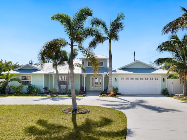 view of front of house with a garage and a front lawn