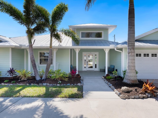 view of front of property featuring a porch and a garage