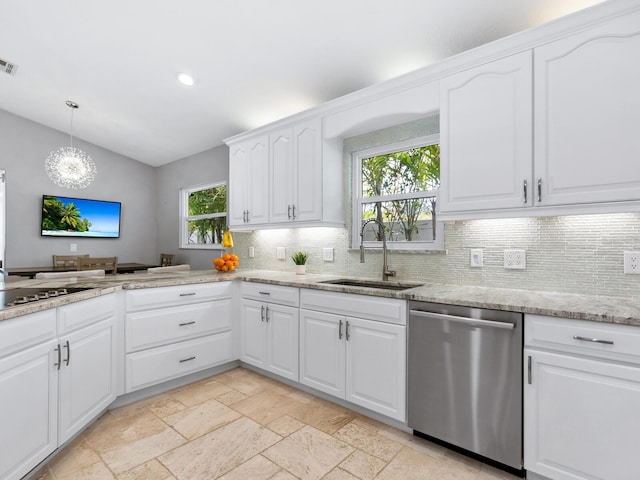 kitchen with sink, white cabinetry, stainless steel appliances, light stone counters, and decorative light fixtures