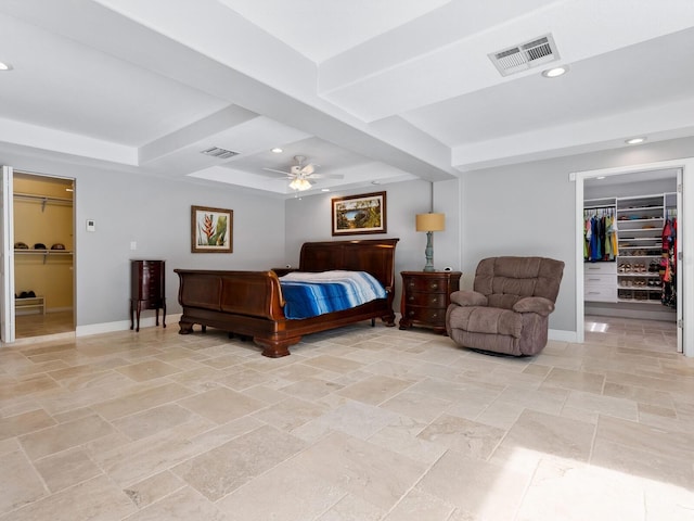 bedroom featuring ceiling fan, a walk in closet, and a closet