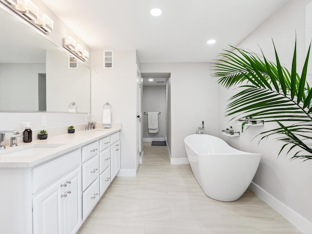 bathroom featuring vanity and a tub to relax in
