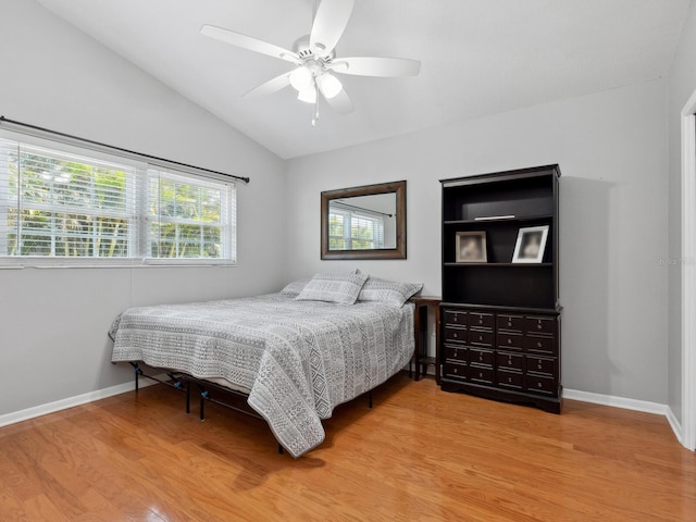 bedroom with wood-type flooring, ceiling fan, and vaulted ceiling