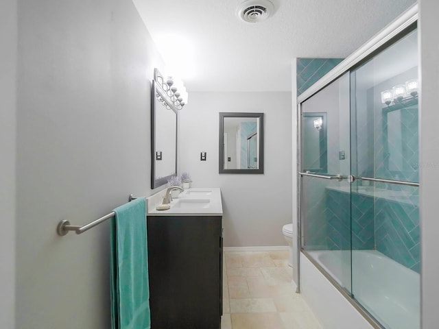 full bathroom with enclosed tub / shower combo, vanity, and toilet