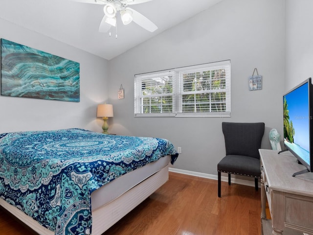bedroom with lofted ceiling, hardwood / wood-style flooring, and ceiling fan