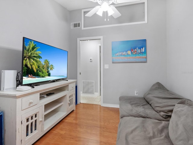 living room with ceiling fan and light wood-type flooring