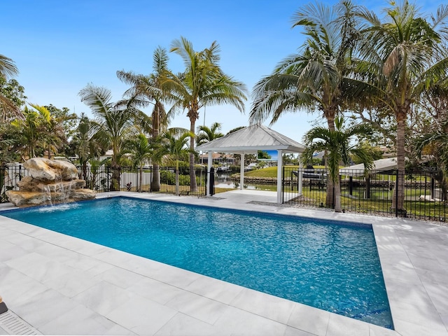 view of swimming pool featuring a gazebo, pool water feature, and a water view