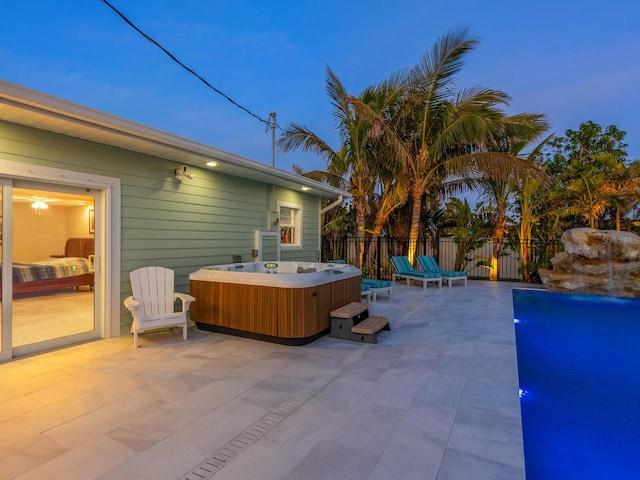 patio terrace at dusk with a hot tub