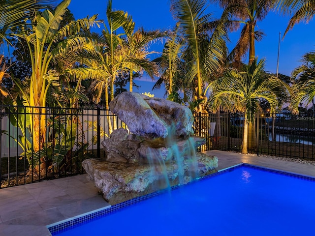 view of pool with pool water feature and a patio