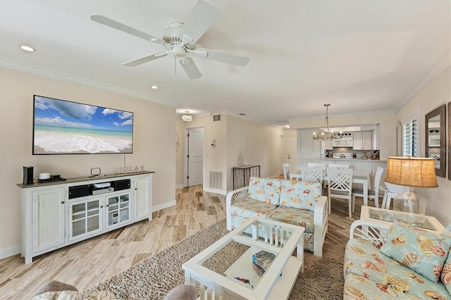 living room featuring crown molding, ceiling fan with notable chandelier, and light hardwood / wood-style floors