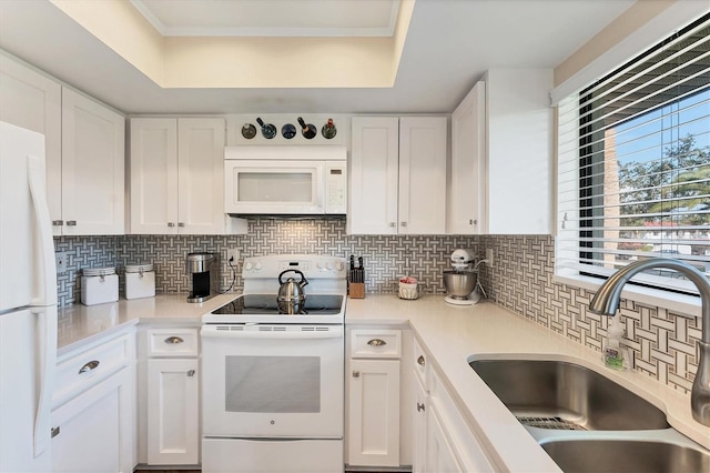 kitchen featuring sink, tasteful backsplash, crown molding, white appliances, and white cabinets